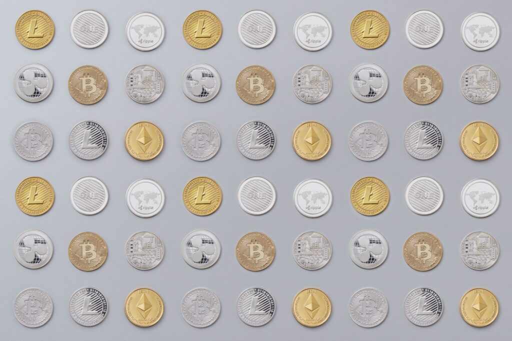 A seamless pattern of various cryptocurrency coins in gold and silver tones.