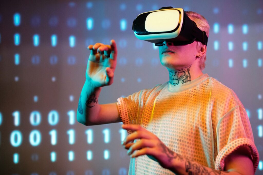 A young man interacts in virtual reality wearing a headset with a digital binary background.